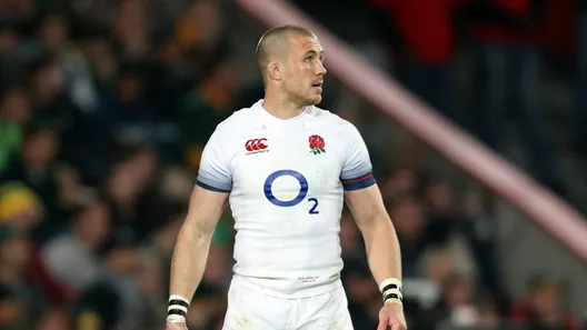 Mike Brown on the pitch in an England rugby shirt, mid-match.